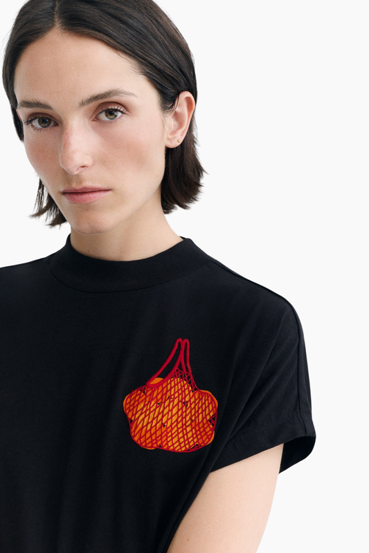 Detalle del patch bordado de mandarinas de la camiseta Volta de Thinking Mu sobre algodón orgánico negro