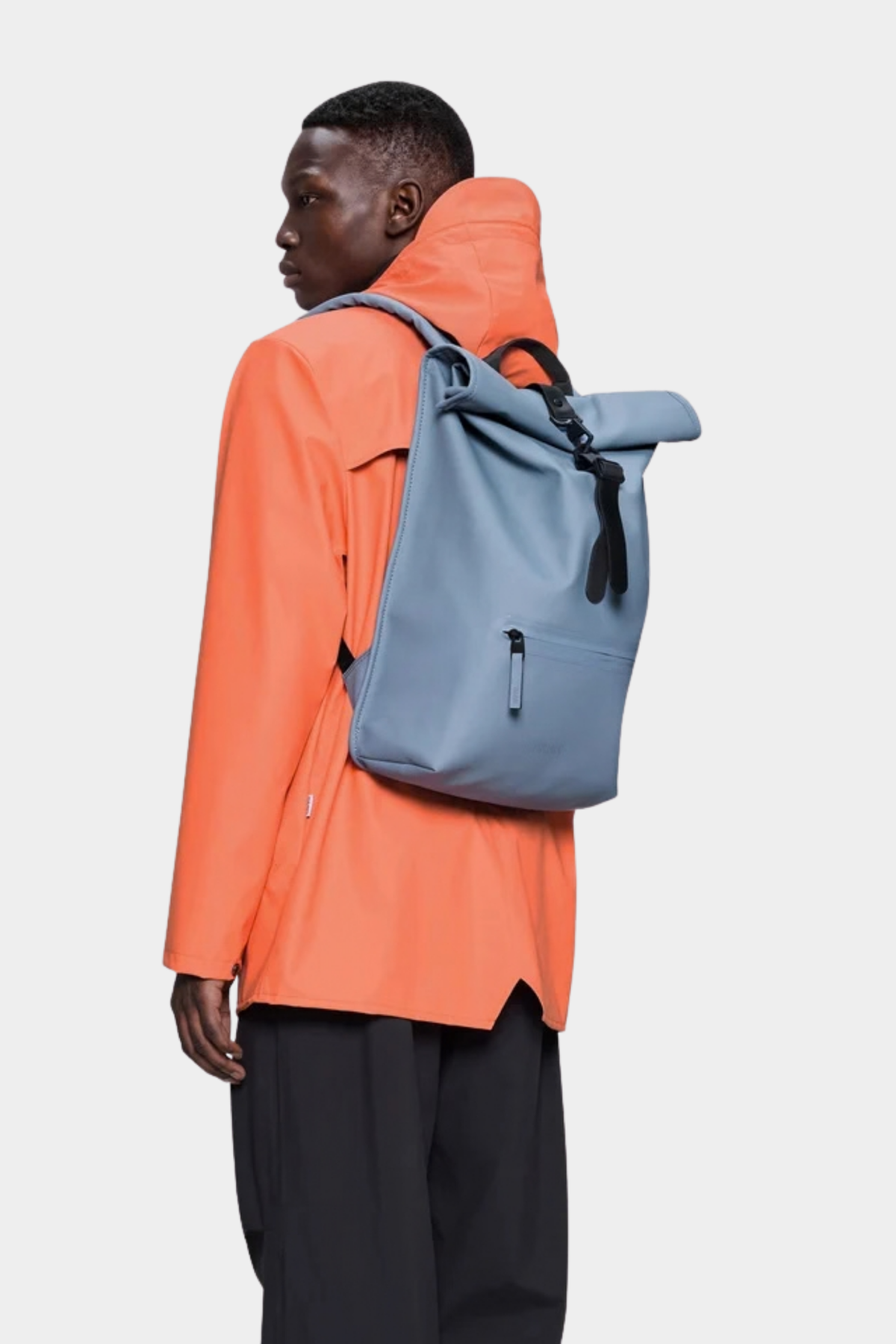Mochila Rains Rolltop Rucksack Blue Dusk puesta, con diseño urbano e impermeable para uso diario