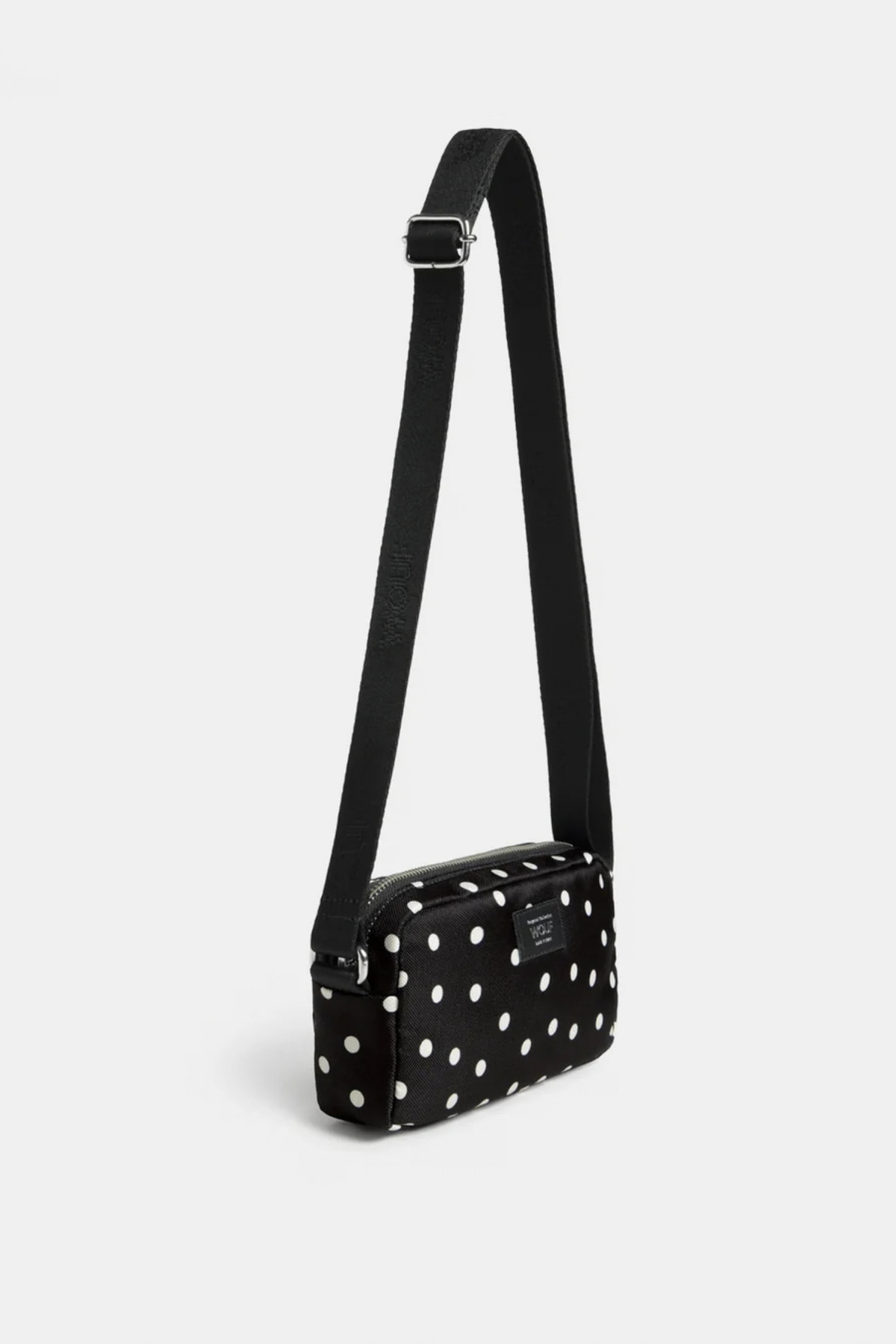 Vista lateral del mini bolso Wouf Grace con lunares blancos, tejido reciclado y acabado repelente al agua